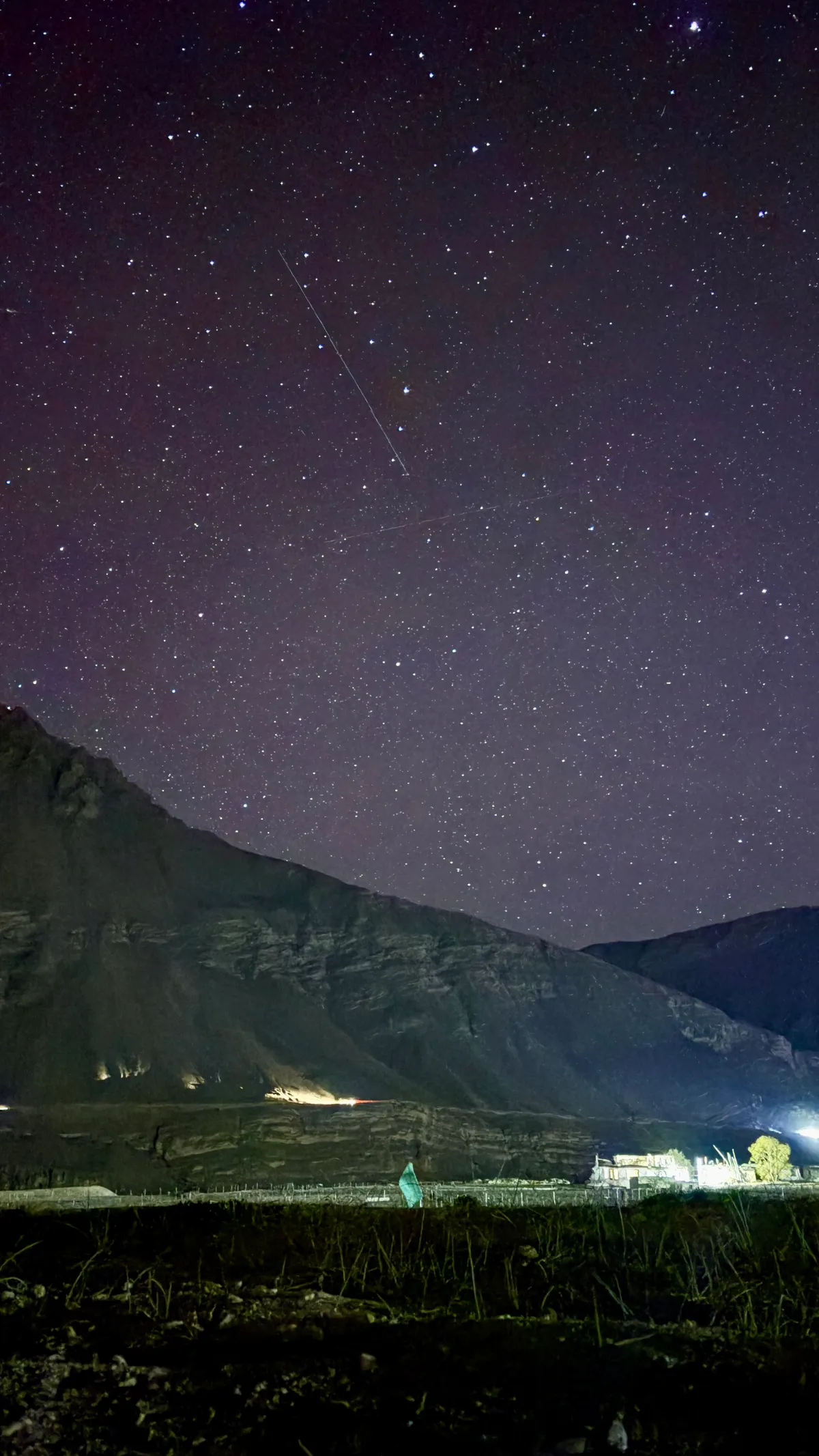 Lights below, a streak above.